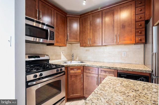 1111 Arlington Blvd Unit 707, Arlington, VA 22209 - kitchen with appliances with stainless steel finishes, backsplash, light stone counters, and brown cabinets