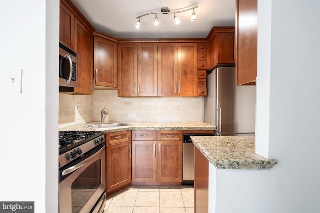 1111 Arlington Blvd Unit 707, Arlington, VA 22209 - kitchen featuring stainless steel appliances, backsplash, brown cabinetry, light tile patterned floors, and light stone countertops