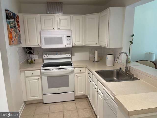 23 Pierside Dr Unit T-12, Baltimore, MD 21230 - kitchen featuring white appliances, tasteful backsplash, light countertops, and light tile patterned floors