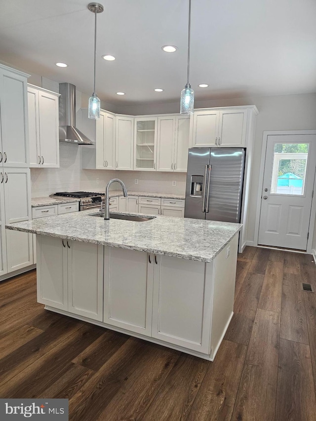 201 Lawrence Ln, Colonial Beach, VA 22443 - kitchen with wall chimney range hood, stainless steel appliances, white cabinetry, an island with sink, and glass insert cabinets