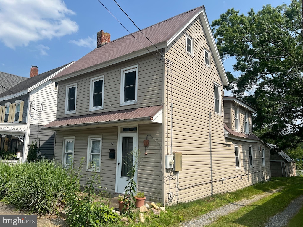 117 Broad St, Milton, DE 19968 - view of front facade with a chimney and a metal roof