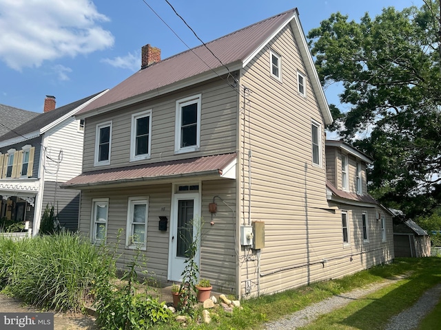 117 Broad St, Milton, DE 19968 - view of front facade with a chimney and a metal roof