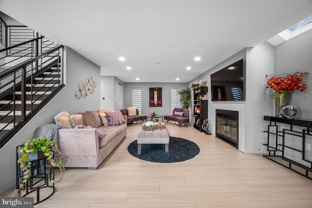 110 Rue Du Boise, Cherry Hill, NJ 08003 - living room with a glass covered fireplace, stairs, recessed lighting, wood finished floors, and a skylight