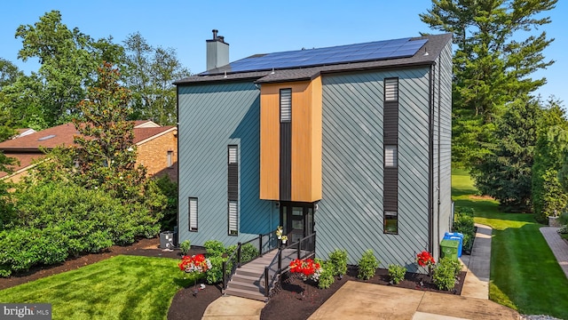 110 Rue Du Boise, Cherry Hill, NJ 08003 - view of property exterior featuring a yard, solar panels, and a chimney