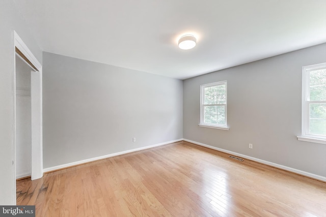 6260 Alpine Ct, Sunderland, MD 20689 - unfurnished bedroom featuring multiple windows, wood finished floors, and a closet