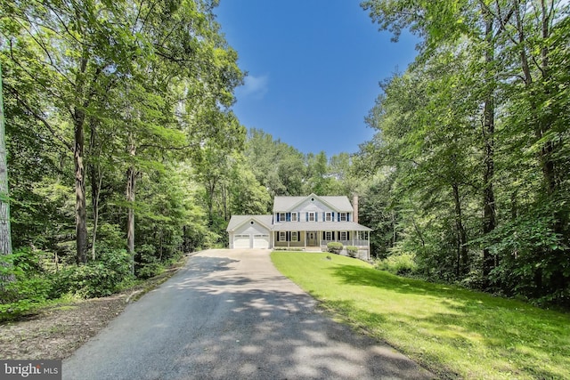 6260 Alpine Ct, Sunderland, MD 20689 - colonial-style house with a front lawn, a view of trees, a chimney, a detached garage, and a porch