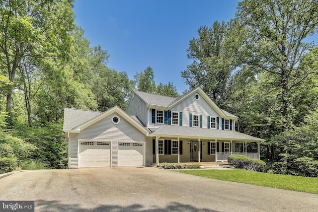 6260 Alpine Ct, Sunderland, MD 20689 - colonial-style house with a porch, a garage, concrete driveway, and roof with shingles