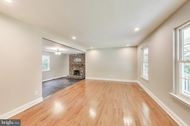 6260 Alpine Ct, Sunderland, MD 20689 - unfurnished living room featuring wood finished floors, a brick fireplace, and recessed lighting