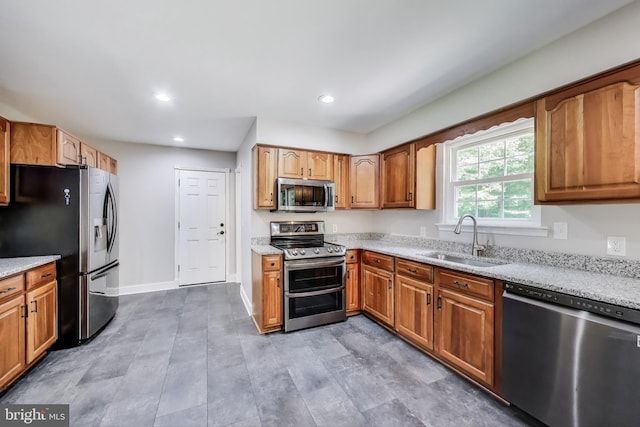 6260 Alpine Ct, Sunderland, MD 20689 - kitchen featuring appliances with stainless steel finishes, light stone countertops, recessed lighting, and brown cabinets