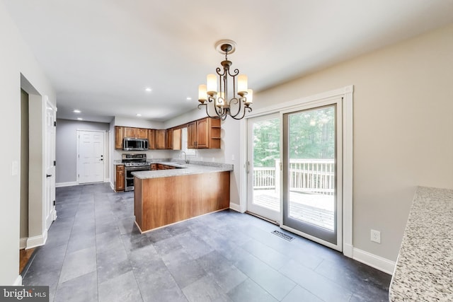 6260 Alpine Ct, Sunderland, MD 20689 - kitchen with stainless steel appliances, open shelves, a chandelier, brown cabinetry, and recessed lighting