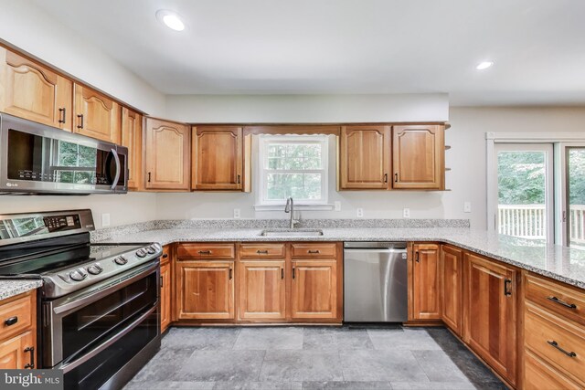 6260 Alpine Ct, Sunderland, MD 20689 - kitchen featuring stainless steel appliances, light stone countertops, recessed lighting, brown cabinetry, and a peninsula