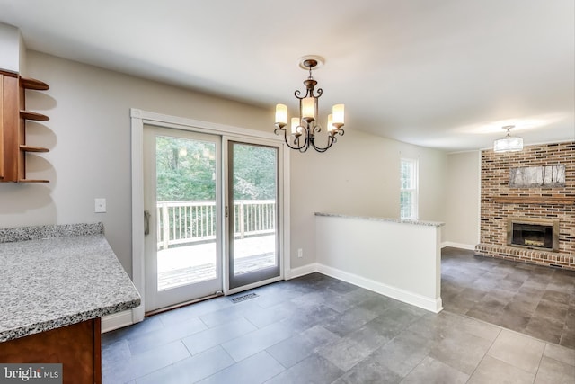 6260 Alpine Ct, Sunderland, MD 20689 - unfurnished dining area with a chandelier and a fireplace