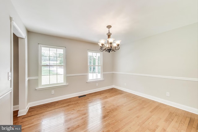 6260 Alpine Ct, Sunderland, MD 20689 - unfurnished room with a chandelier and hardwood / wood-style floors