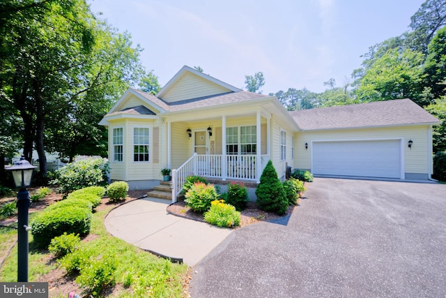 22890 Zoar Rd, Georgetown, DE 19947 - view of front of house with covered porch, driveway, a garage, and a shingled roof
