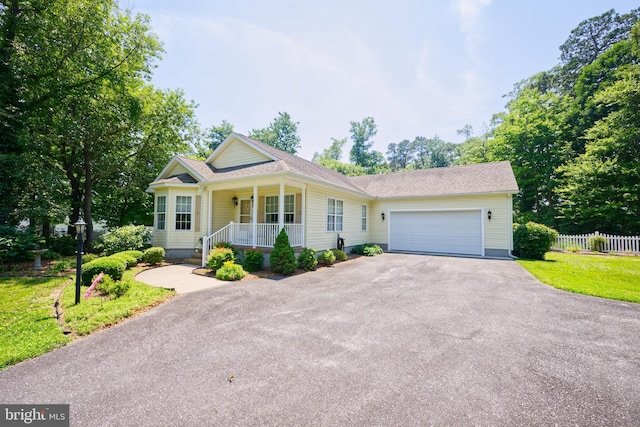 22890 Zoar Rd, Georgetown, DE 19947 - view of front of house featuring covered porch, asphalt driveway, a garage, and a shingled roof