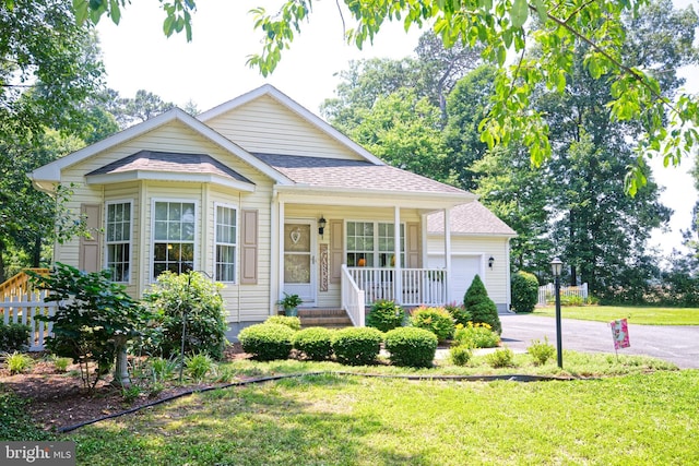 22890 Zoar Rd, Georgetown, DE 19947 - bungalow-style house featuring covered porch, driveway, an attached garage, and a front yard