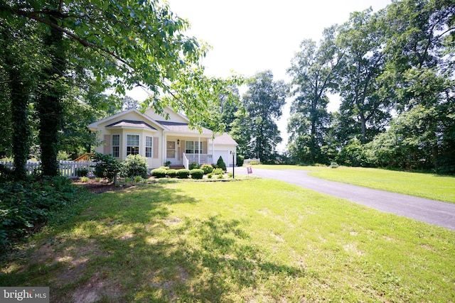 22890 Zoar Rd, Georgetown, DE 19947 - view of front of home with a porch, a front lawn, a garage, and asphalt driveway
