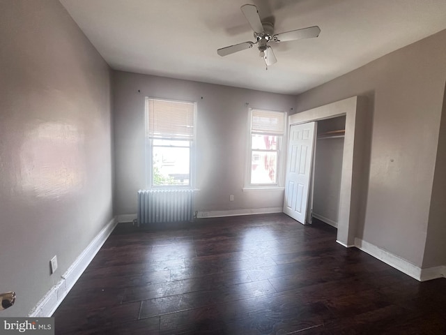 2238 N Bancroft St, Philadelphia, PA 19132 - unfurnished bedroom featuring dark wood-type flooring, radiator heating unit, a closet, and a ceiling fan