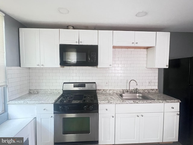 2238 N Bancroft St, Philadelphia, PA 19132 - kitchen with black microwave, gas stove, and white cabinets