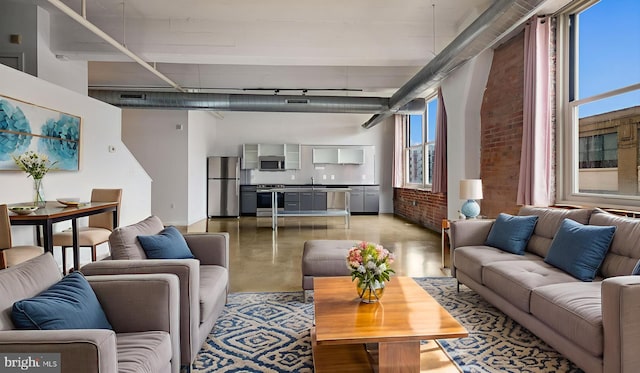 444 N 4th St Unit 401, Philadelphia, PA 19123 - living area with concrete floors, a towering ceiling, and brick wall