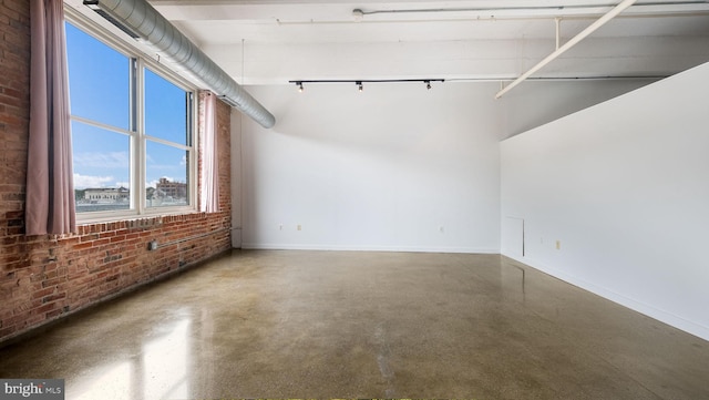 444 N 4th St Unit 401, Philadelphia, PA 19123 - spare room featuring brick wall, finished concrete flooring, and a towering ceiling