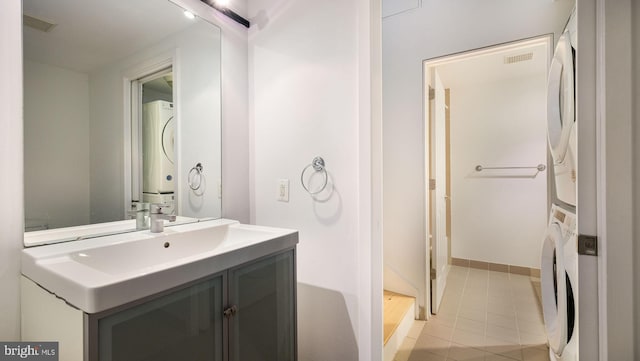 444 N 4th St Unit 401, Philadelphia, PA 19123 - bathroom featuring stacked washer and clothes dryer, vanity, and tile patterned floors