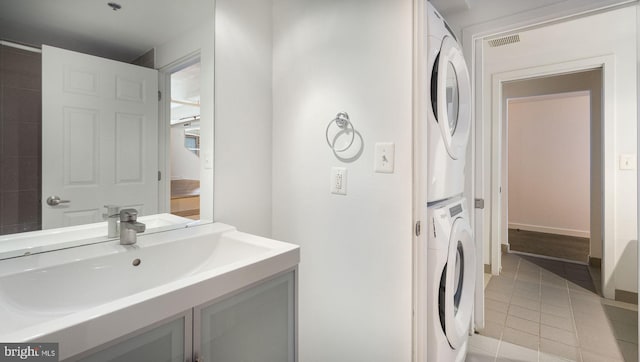 444 N 4th St Unit 401, Philadelphia, PA 19123 - laundry room featuring stacked washing machine and dryer and light tile patterned floors