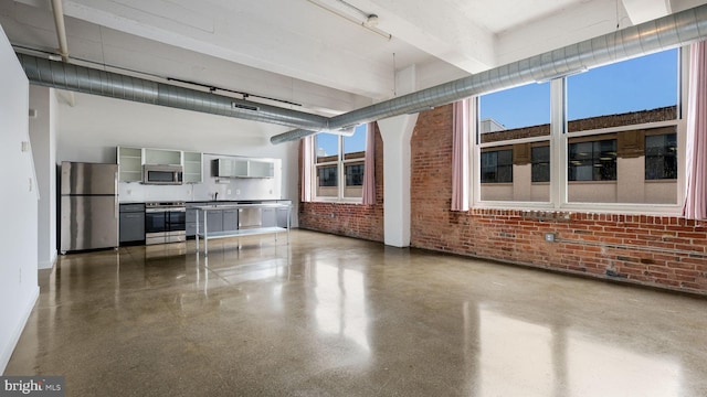 444 N 4th St Unit 401, Philadelphia, PA 19123 - unfurnished living room with brick wall, a high ceiling, speckle patterned floor, and beamed ceiling