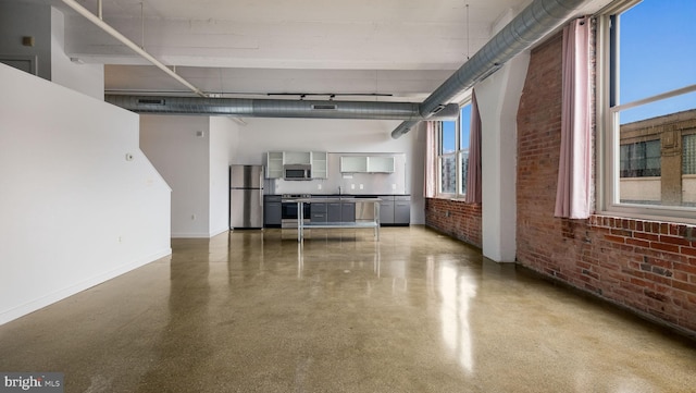 444 N 4th St Unit 401, Philadelphia, PA 19123 - unfurnished living room with brick wall, a high ceiling, and speckled floor
