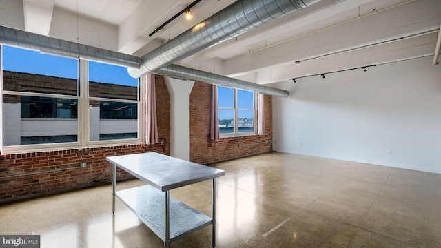 444 N 4th St Unit 401, Philadelphia, PA 19123 - unfurnished room featuring brick wall and track lighting
