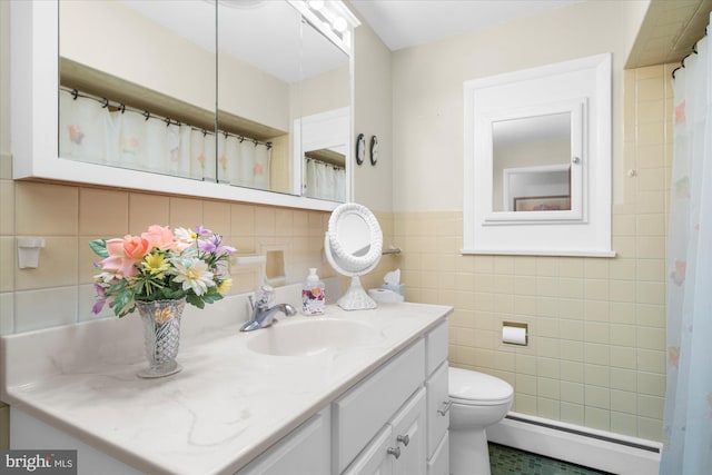 1122 N 14th St, Allentown, PA 18102 - bathroom with baseboard heating, tile walls, vanity, and wainscoting