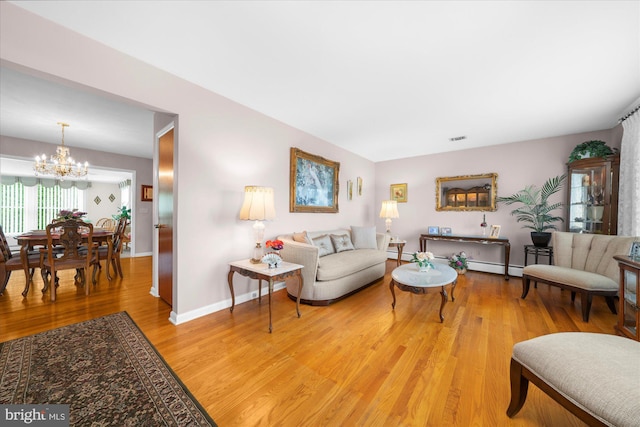 1122 N 14th St, Allentown, PA 18102 - living room with light wood-style floors, a baseboard heating unit, and a chandelier