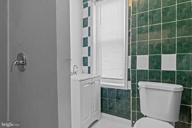 bathroom featuring tile walls, vanity, and tile patterned flooring