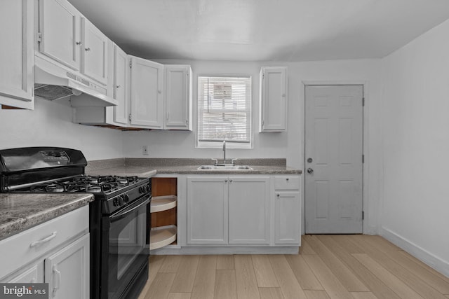 kitchen with black range with gas cooktop, under cabinet range hood, light wood-style flooring, and white cabinetry