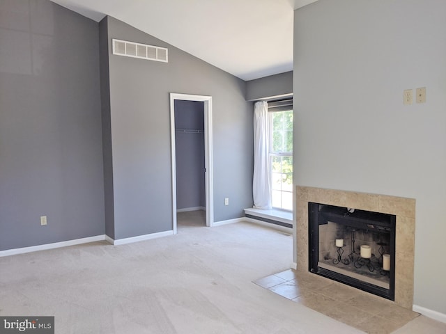 74 Avon Ln Unit 7D, New Hope, PA 18938 - unfurnished living room with vaulted ceiling, a tiled fireplace, and carpet flooring