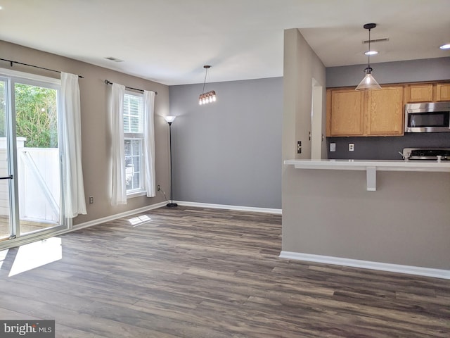 74 Avon Ln Unit 7D, New Hope, PA 18938 - kitchen with stainless steel microwave, dark wood-style floors, range, pendant lighting, and recessed lighting