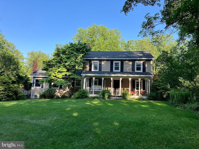 17435 Big Falls Rd, Monkton, MD 21111 - colonial home featuring covered porch, a front yard, and a chimney