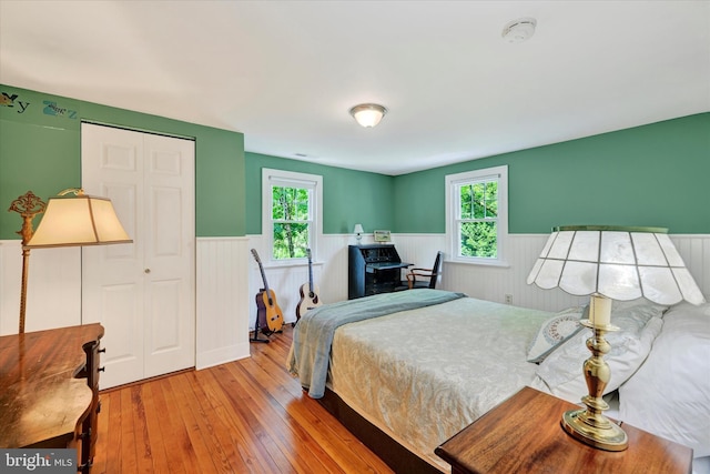 17435 Big Falls Rd, Monkton, MD 21111 - bedroom featuring a wainscoted wall, hardwood / wood-style floors, multiple windows, and a closet