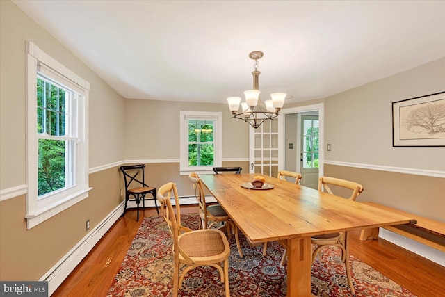 17435 Big Falls Rd, Monkton, MD 21111 - dining room with a baseboard radiator, wood finished floors, and a chandelier