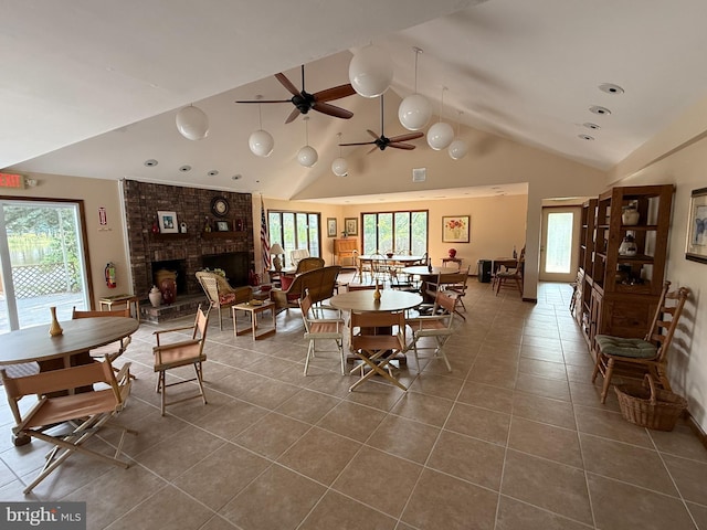 170 E Holly Ln, Tuckerton, NJ 08087 - dining space with dark tile patterned floors, plenty of natural light, a brick fireplace, beamed ceiling, and a ceiling fan