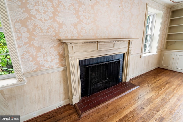 6316 Mossway, Baltimore, MD 21212 - detailed view of wallpapered walls, wood finished floors, a fireplace with raised hearth, and a wainscoted wall