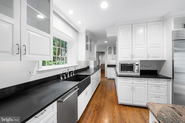 6316 Mossway, Baltimore, MD 21212 - kitchen featuring appliances with stainless steel finishes, wood finished floors, white cabinets, glass insert cabinets, and recessed lighting