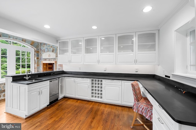 6316 Mossway, Baltimore, MD 21212 - kitchen featuring stainless steel dishwasher, a peninsula, dark countertops, white cabinetry, and glass insert cabinets
