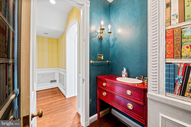 6316 Mossway, Baltimore, MD 21212 - bathroom featuring wood finished floors, vanity, and a wainscoted wall