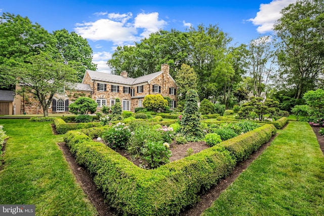 6316 Mossway, Baltimore, MD 21212 - back of property with stone siding, a chimney, and a yard