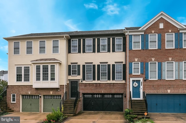 542 Glade Fern Ter SE, Leesburg, VA 20175 - view of property featuring a garage, brick siding, and concrete driveway