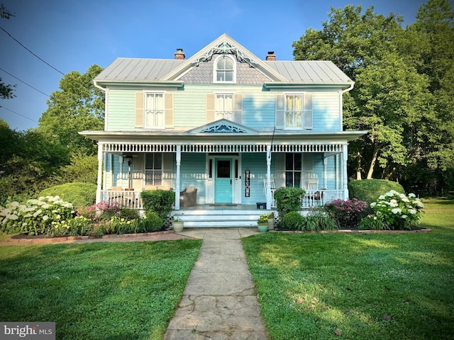 10 New Cut Rd, Round Hill, VA 20141 - victorian-style house with covered porch, a chimney, a front lawn, and a standing seam roof
