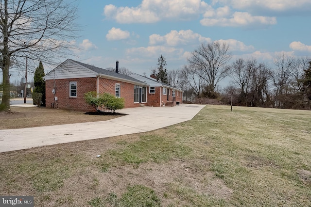 2502 Rancocas Rd, Burlington, NJ 08016 - view of side of property featuring brick siding, concrete driveway, a chimney, and a lawn