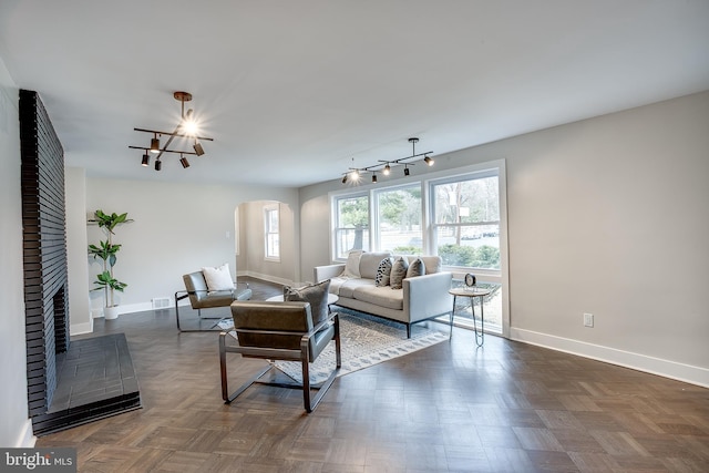2502 Rancocas Rd, Burlington, NJ 08016 - living area with a chandelier, arched walkways, and a fireplace