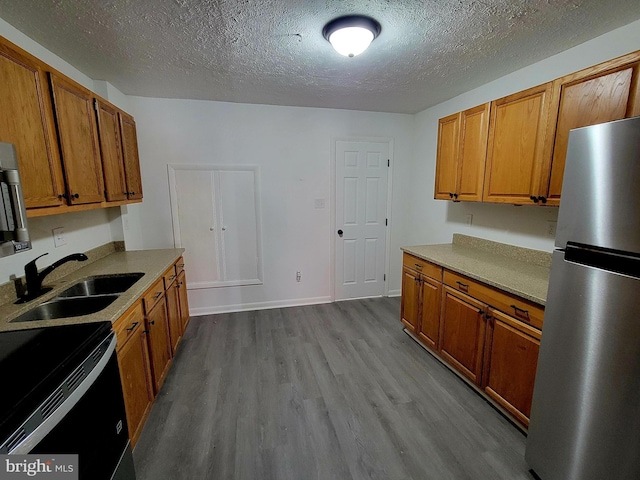 110 N Mulberry St, Hagerstown, MD 21740 - kitchen with freestanding refrigerator, dark wood-style floors, brown cabinets, a textured ceiling, and light countertops
